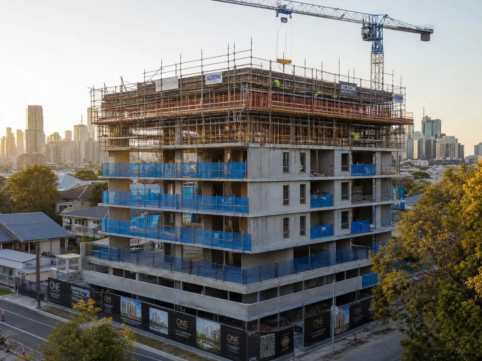 Australian medium-rise apartment building under construction with tower crane and formwork